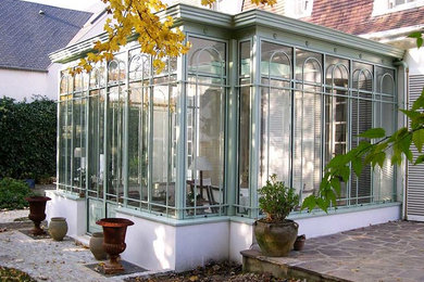 Small traditional sunroom in Paris with no fireplace and a skylight.