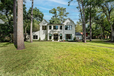 Large transitional white two-story concrete fiberboard and clapboard exterior home photo in Houston with a shingle roof and a black roof
