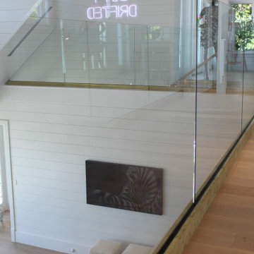 Glass Balustrade with Aluminum Base Rail Finished with Satin Brass Cladding