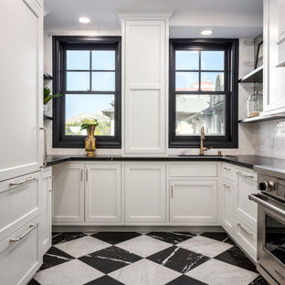 Small transitional u-shaped kitchen in Salt Lake City with an undermount sink, beaded inset cabinets, white cabinets, quartz benchtops, white splashback, marble splashback, panelled appliances, marble floors, no island, multi-coloured floor and black benchtop.