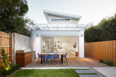 Design ideas for a mid-sized contemporary backyard patio in Melbourne with decking and a pergola.