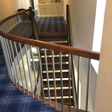 Matching gallery landing on this contemporary curved helical staircase in beauti