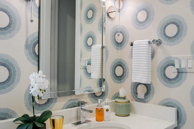 Powder room - mid-sized transitional powder room idea in Dallas with shaker cabinets, white cabinets, a one-piece toilet, multicolored walls, an undermount sink and quartzite countertops