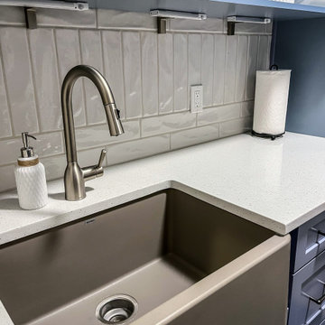 Laundry Room with Blue Painted Cabinetry and Sparkling White Quartz Countertops