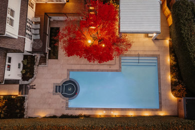 Inspiration for a backyard concrete paver and l-shaped lap pool remodel in Vancouver with a bbq area