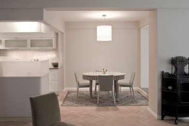 Photo of a small modern dining room in New York with concrete floors and grey floor.