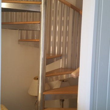 Spiral stairs with wood maple treads and handrail.