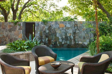 Inspiration for a mid-sized contemporary backyard patio in Dallas with a pergola, a water feature and tile.