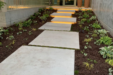 This is an example of a modern front yard mulch and metal fence walkway in Salt Lake City.