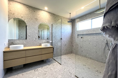 Design ideas for a contemporary master bathroom in Sunshine Coast with flat-panel cabinets, light wood cabinets, a double shower, gray tile, ceramic floors, a vessel sink, laminate benchtops, grey floor, an open shower, a double vanity and a built-in vanity.