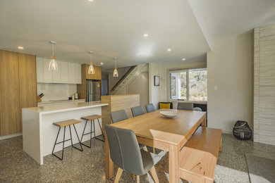 Mid-sized beach style kitchen/dining combo in Other with beige walls, ceramic floors and beige floor.