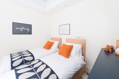 Contemporary bedroom in London with white walls.