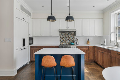 Eat-in kitchen - large transitional l-shaped dark wood floor and brown floor eat-in kitchen idea in New York with a drop-in sink, shaker cabinets, dark wood cabinets, quartz countertops, multicolored backsplash, ceramic backsplash, stainless steel appliances, an island and white countertops