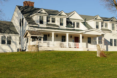 Large white two-story wood exterior home photo in Burlington