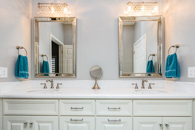 Example of a mid-sized classic master bathroom design in Phoenix with raised-panel cabinets, white cabinets, gray walls, an undermount sink and quartzite countertops