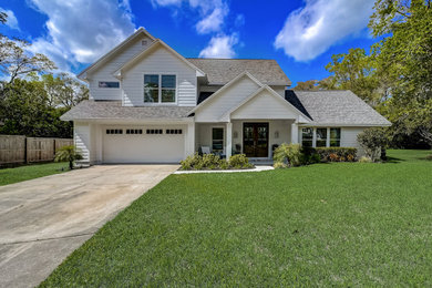 Large transitional white two-story clapboard house exterior idea in Jacksonville with a shingle roof and a gray roof