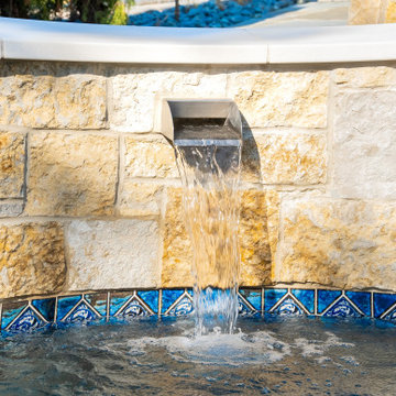 Naperville, IL freeform swimming pool with hot tub, large sunshelf, glass tile