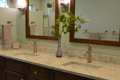 Large transitional master porcelain tile and gray floor bathroom photo in DC Metro with flat-panel cabinets, brown cabinets, a one-piece toilet, blue walls, an undermount sink, quartz countertops, a hinged shower door, blue countertops and a built-in vanity