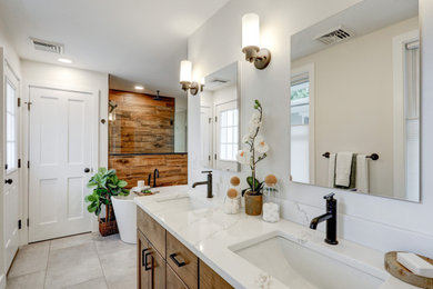 Inspiration for a large modern master bathroom in Other with recessed-panel cabinets, brown cabinets, a freestanding tub, an open shower, a two-piece toilet, brown tile, wood-look tile, grey walls, vinyl floors, an undermount sink, engineered quartz benchtops, grey floor, an open shower, white benchtops, a laundry, a double vanity and a built-in vanity.