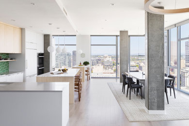 Inspiration for a large modern light wood floor and beige floor kitchen/dining room combo remodel in Portland with white walls