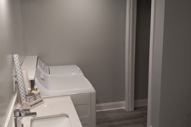 Inspiration for a modern laundry room remodel in Other with gray walls and a side-by-side washer/dryer