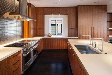 Example of a large trendy l-shaped dark wood floor eat-in kitchen design in Philadelphia with an undermount sink, flat-panel cabinets, medium tone wood cabinets, concrete countertops, black backsplash, subway tile backsplash, stainless steel appliances and an island