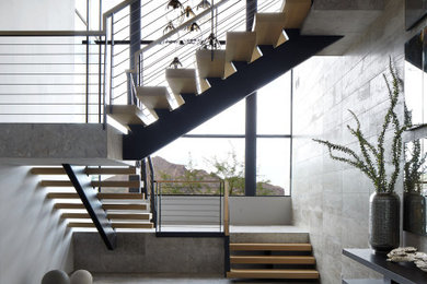 Inspiration for a wooden metal railing staircase remodel in Phoenix