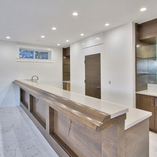 Large modern walk-out basement in Calgary with white walls, marble flooring, a standard fireplace and a stone fireplace surround.