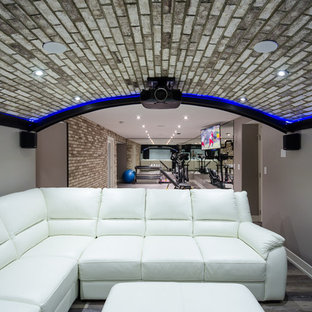 Mid-sized trendy open concept vinyl floor home theater photo in Calgary with gray walls and a projector screen