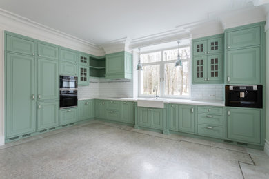 This is an example of a large traditional l-shaped eat-in kitchen in Moscow with a double-bowl sink, shaker cabinets, green cabinets, solid surface benchtops, white splashback, subway tile splashback, black appliances, no island and white benchtop.