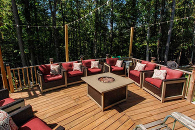 Inspiration for a mid-sized timeless backyard deck remodel in Atlanta with a fire pit and an awning