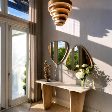 Sunlit Entryway with Sculptural Console and Organic Mirrors