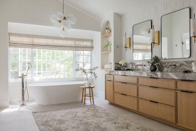 Inspiration for a large contemporary master double-sink freestanding bathtub remodel in San Francisco with shaker cabinets, light wood cabinets, marble countertops and a built-in vanity