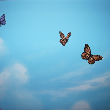 Sky Ceiling Mural with Butterflies, hand-painted in a bedroom by Mural Art LLC.