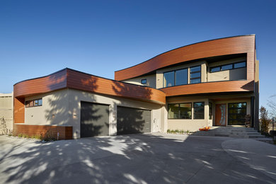 Inspiration for a large modern beige two-story metal exterior home remodel in Edmonton