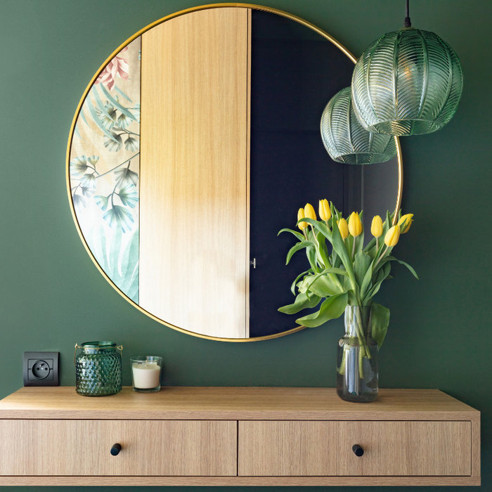 mirror hanging on wall with furniture and decor
