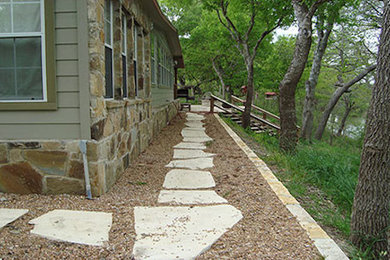 This is an example of a large side yard stone landscaping in Austin.