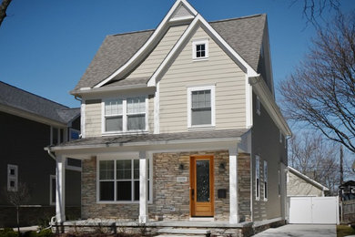 Mid-sized contemporary beige two-story mixed siding exterior home idea in Detroit