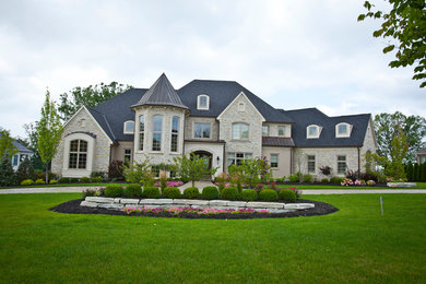 Huge traditional two-story brick exterior home idea in Cincinnati