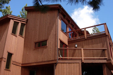 This is an example of a large contemporary three-storey brown exterior in Sacramento with wood siding.