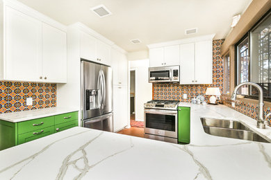 Inspiration for a mid-sized transitional u-shaped brick floor open concept kitchen remodel in Albuquerque with a double-bowl sink, shaker cabinets, green cabinets, marble countertops, multicolored backsplash, porcelain backsplash, stainless steel appliances and a peninsula