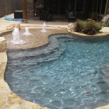 Freeform pool, flagstone coping, beach entry, rico rock boulders, bubblers and r
