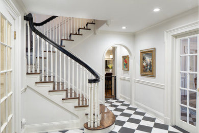 Mid-sized elegant marble floor entryway photo in New York with white walls
