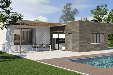 Imagen de fachada de casa minimalista de tamaño medio de una planta con revestimientos combinados, tejado plano y tejado de varios materiales