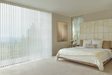 Example of a large trendy master carpeted and beige floor bedroom design in Detroit with beige walls