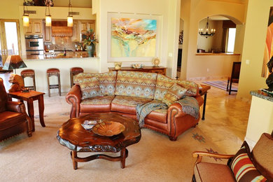 Inspiration for a large southwestern open concept porcelain tile and beige floor living room remodel in Phoenix with beige walls and no fireplace