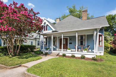 Inspiration for a mid-sized timeless gray one-story wood exterior home remodel in Other with a hip roof