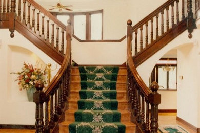 Staircase - mid-sized traditional carpeted curved staircase idea in Seattle with wooden risers