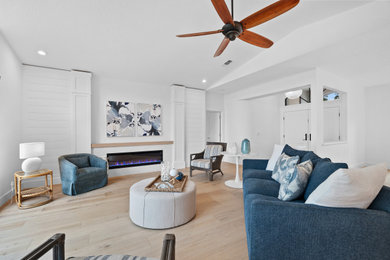 Transitional vaulted ceiling living room photo in Tampa with white walls and a shiplap fireplace
