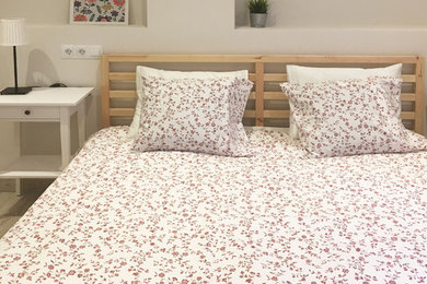 Example of a small danish master porcelain tile and brown floor bedroom design in Malaga with gray walls and no fireplace